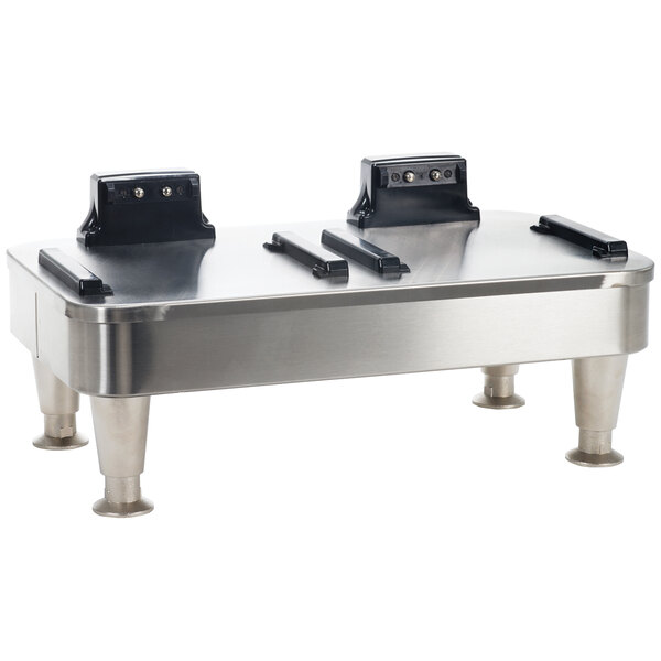 A stainless steel Bunn double server docking stand on a metal table.