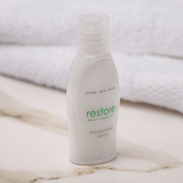 A white bottle of Dial Restore hand and body lotion with green text.