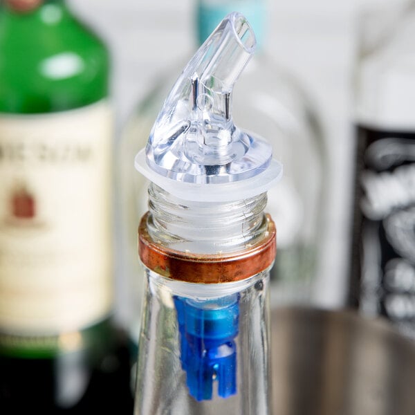 A clear Thunder Group liquor pourer with a blue tail.