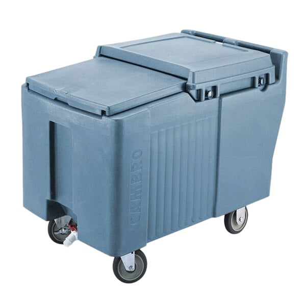 A large Cambro slate blue mobile ice bin with wheels and a sliding lid.