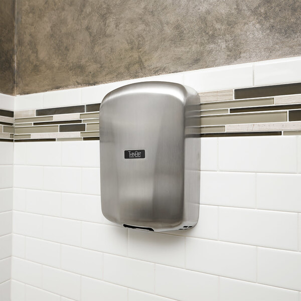 A brushed stainless steel Excel ThinAir hand dryer on a white wall.