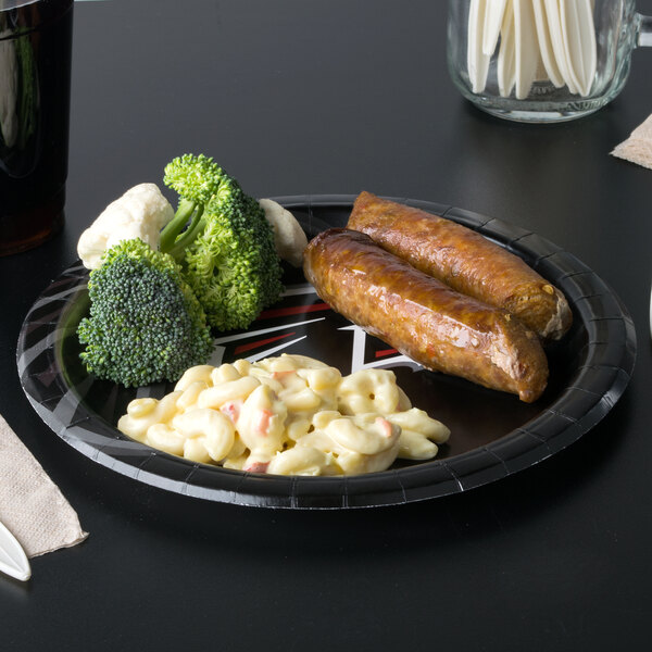 A Creative Converting Atlanta Falcons paper dinner plate with macaroni and cheese and sausage on it.