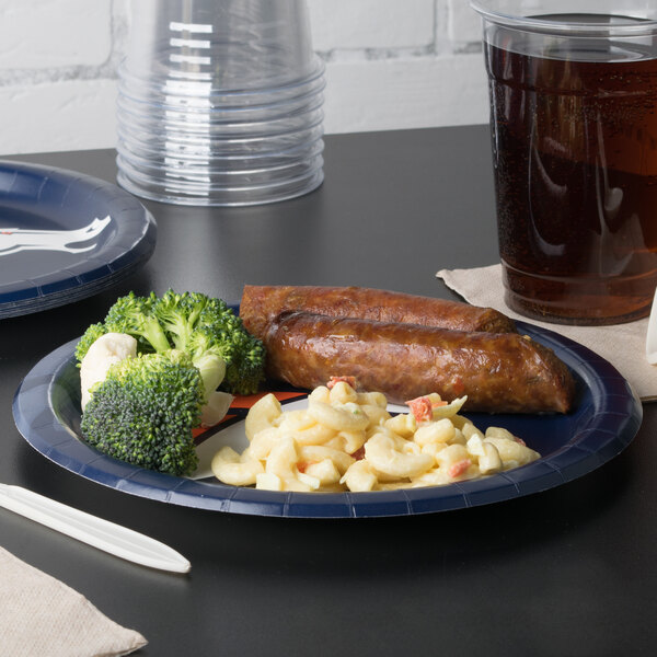 A Denver Broncos paper dinner plate with sausage and broccoli on it.