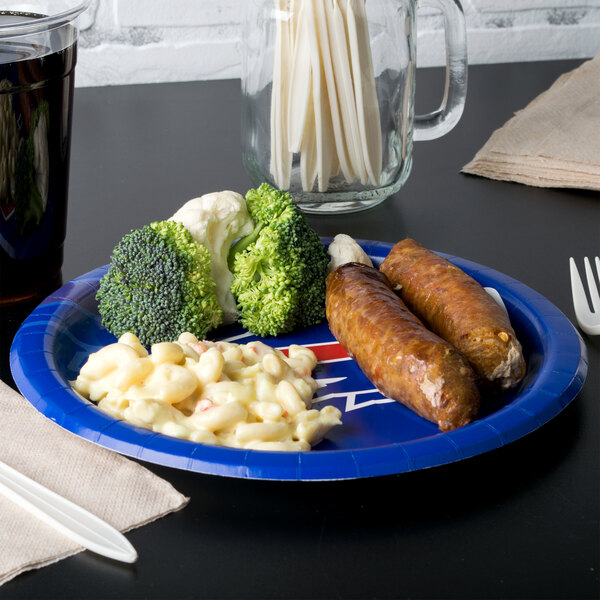 A Creative Converting Buffalo Bills paper dinner plate with sausages, broccoli, and cauliflower on it.