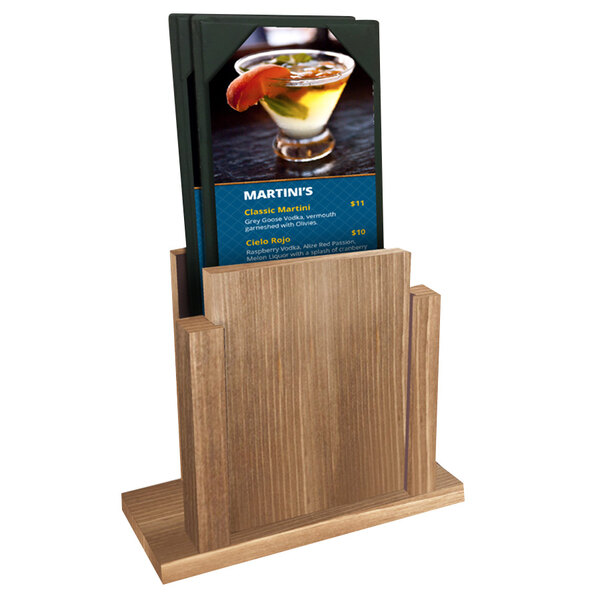A Menu Solutions weathered walnut wood menu holder on a table with a drink.