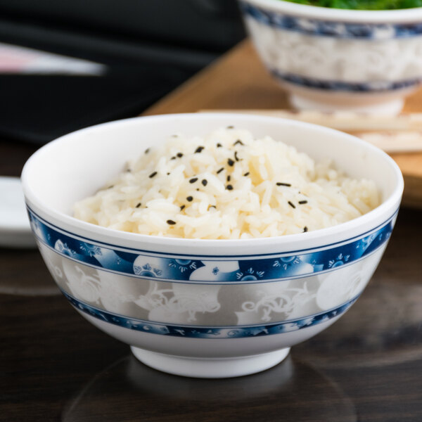 A blue Thunder Group melamine rice bowl filled with rice.