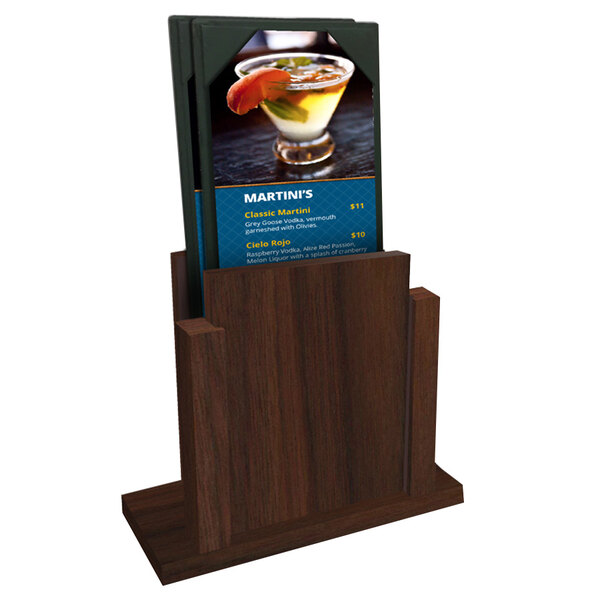 A Menu Solutions walnut wood menu holder with a menu on a table with a drink.
