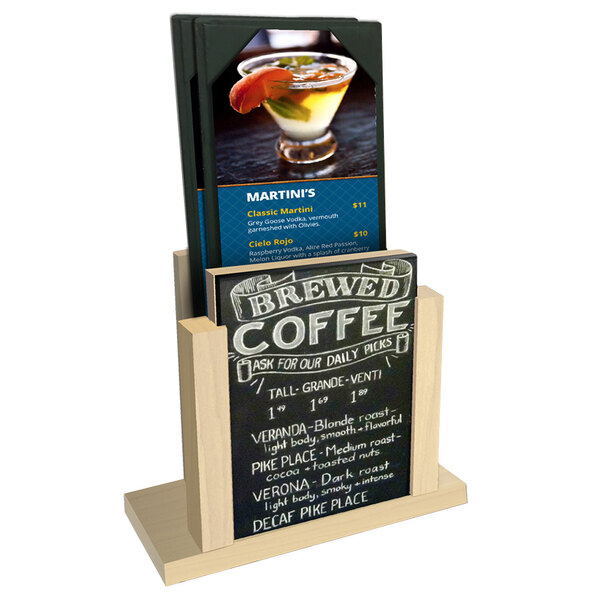 A Menu Solutions natural wood menu holder with a chalkboard insert displaying a drink menu on a table with a drink.