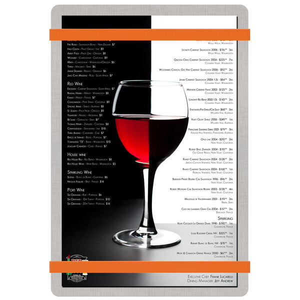 A Menu Solutions brushed aluminum menu board with orange bands on a wine glass.