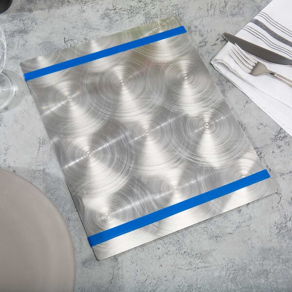 A silver plate with a Menu Solutions Alumitique royal blue banded on a napkin with silverware.