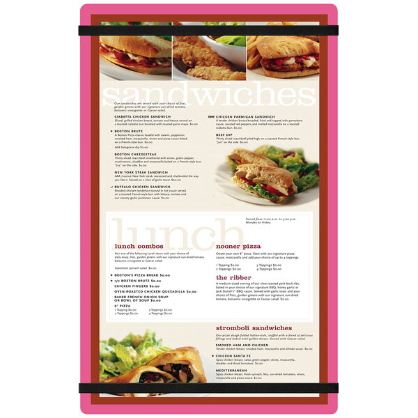 A Menu Solutions customizable acrylic menu board with pink rubber band straps on a table with a sandwich and salad.
