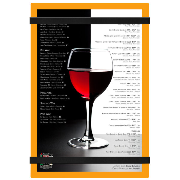 A Menu Solutions orange acrylic menu board with rubber band straps on a wine glass.