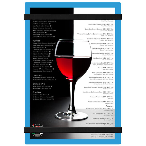 A wine glass with a blue customizable acrylic menu board with rubber band straps on it.
