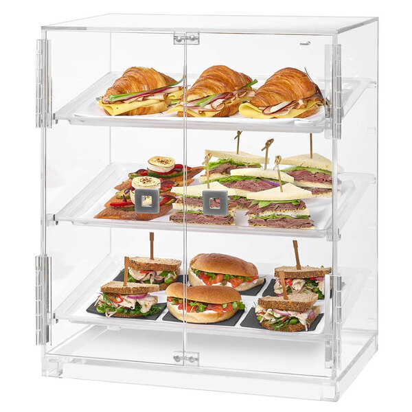 A Rosseto small clear acrylic bakery display case with frosted trays holding croissant and sandwich varieties.