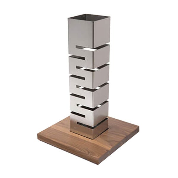A Rosseto stainless steel multi-level riser with a walnut base.