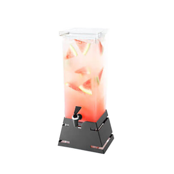 A Rosseto clear acrylic beverage dispenser with a black and grey pyramid base and a spigot filled with watermelon slices.