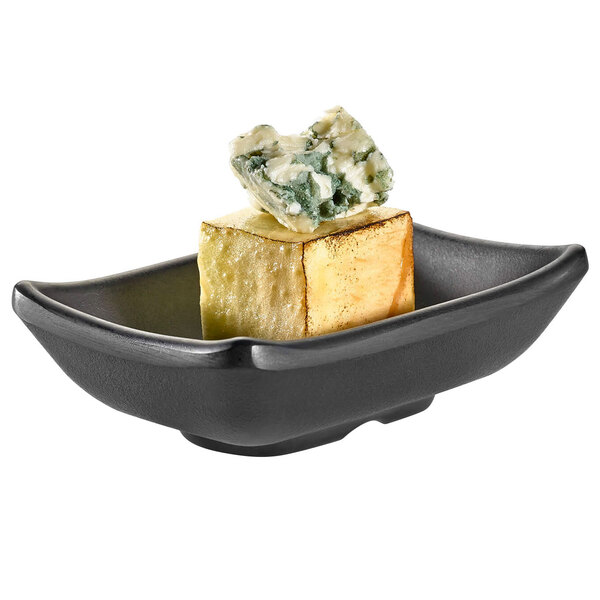 A piece of blue cheese on a black Rosseto melamine rectangle bowl.