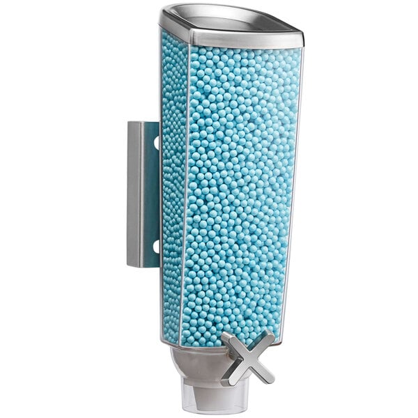 A wall-mounted metal candy dispenser with a blue ball inside.