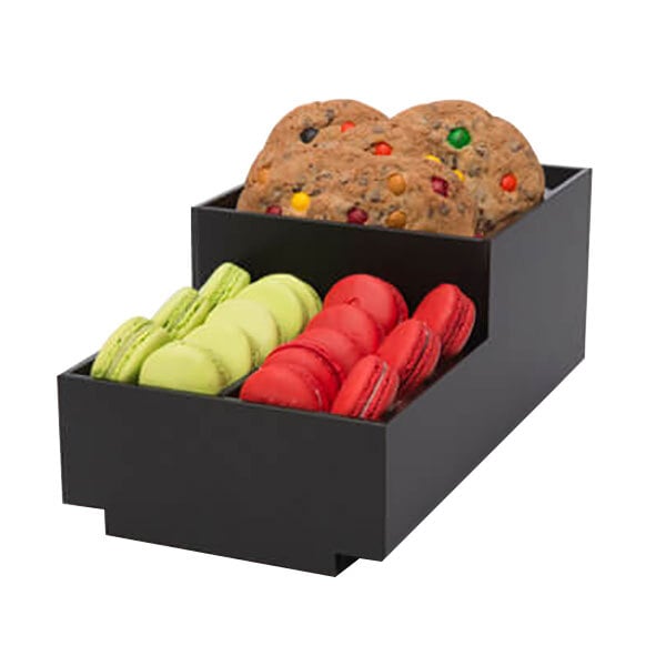 A black Rosseto condiment holder on a counter with cookies and macaroons.