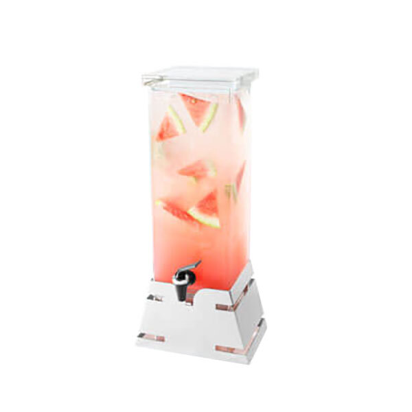 A clear plastic beverage dispenser with a stainless steel base filled with water and watermelon slices.