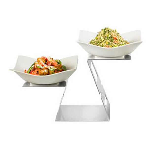 A Rosseto stainless steel display riser with two bowls of food.