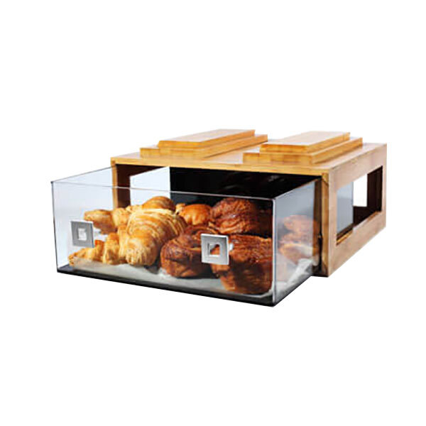 A natural bamboo drawer with glass holding food in a bakery display.