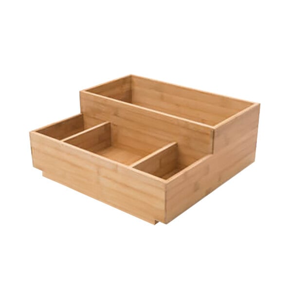 A wooden box with four compartments on a table.