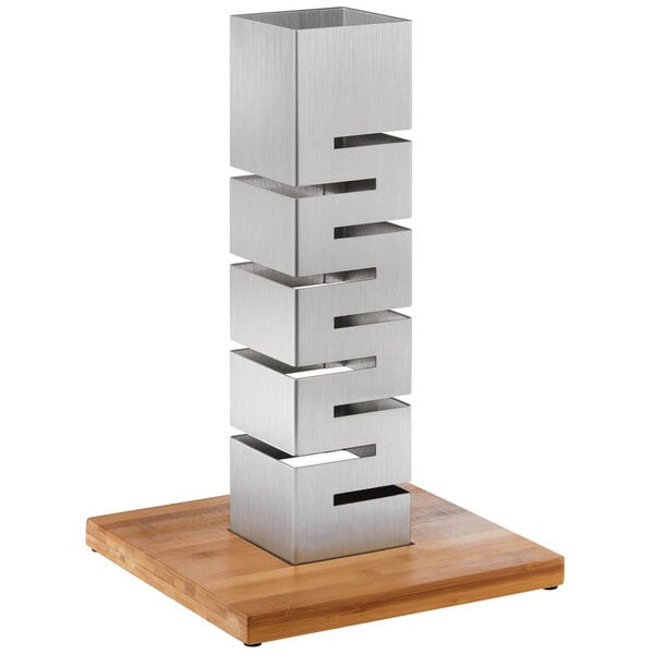A Rosseto stainless steel tower with four levels on a bamboo base.