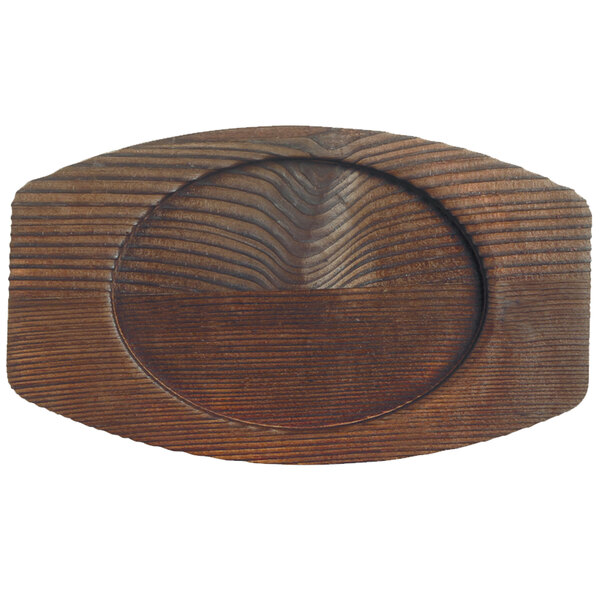 A wooden oval Libbey cedar plank underliner with a carved surface.