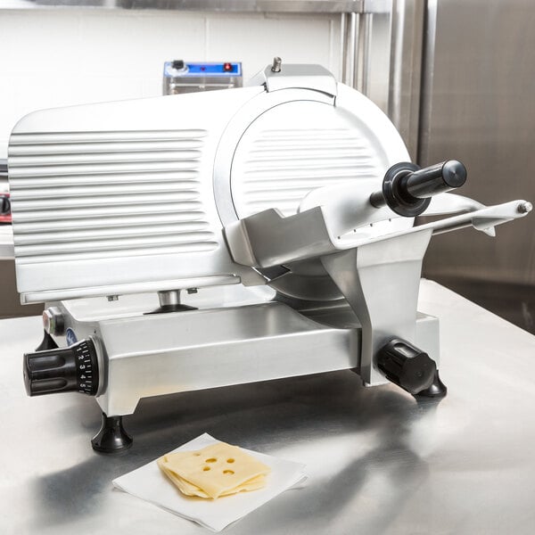 A Globe Chefmate manual gravity feed meat slicer on a counter.