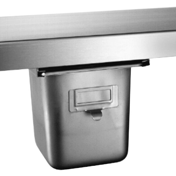 A stainless steel spice bin with a lid in a metal drawer.