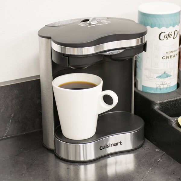 A Conair Cuisinart coffee maker with a cup of coffee on the counter.
