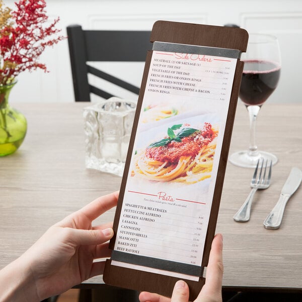 A person holding a Menu Solutions wood menu board with rubber bands.