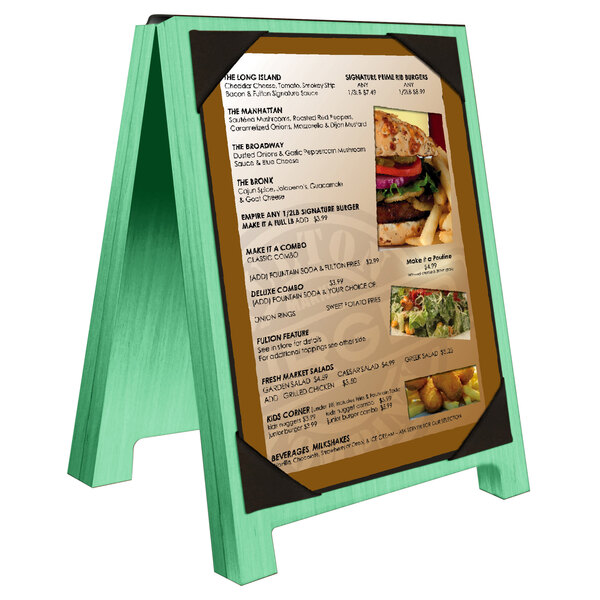 A washed teal wood Menu Solutions menu board tent with picture corners holding a menu.