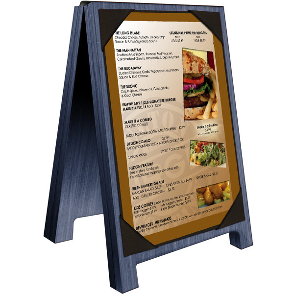 A Menu Solutions denim wood sandwich menu board with a menu on a table with a burger and picture corners.