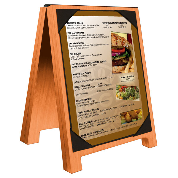A Menu Solutions wooden menu board with picture corners and black trim displaying a close up of a salad.