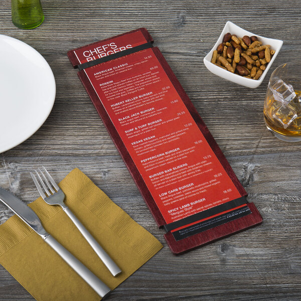 A Menu Solutions mahogany wood menu board on a table with a fork and knife.