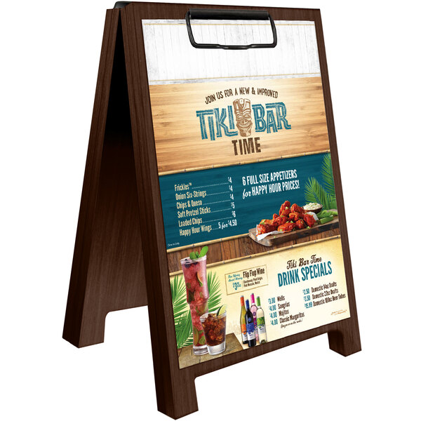 A Menu Solutions walnut wood sandwich menu board tent on a table with a menu on it.