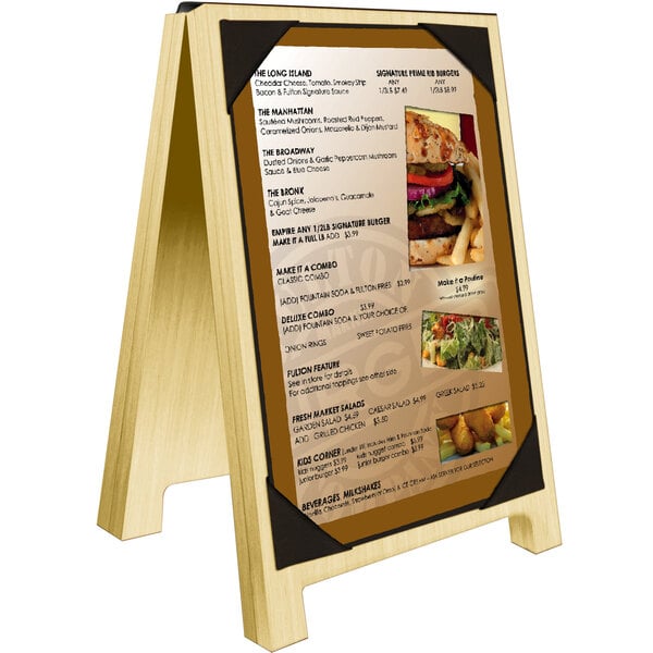 A Menu Solutions natural wood sandwich menu board with a menu and picture corners on a table.