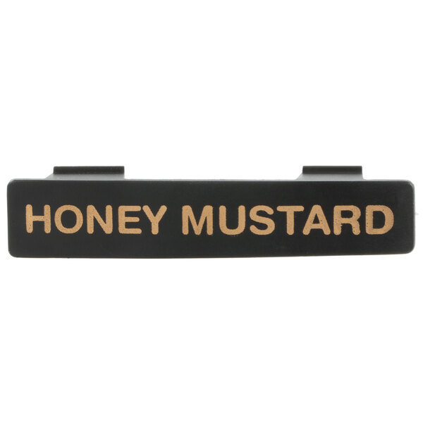 A black rectangular Tablecraft dispenser tag with gold text reading "Honey Mustard"