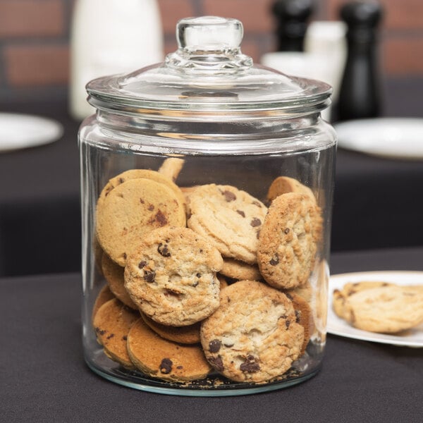 An Anchor Hocking glass jar filled with cookies.