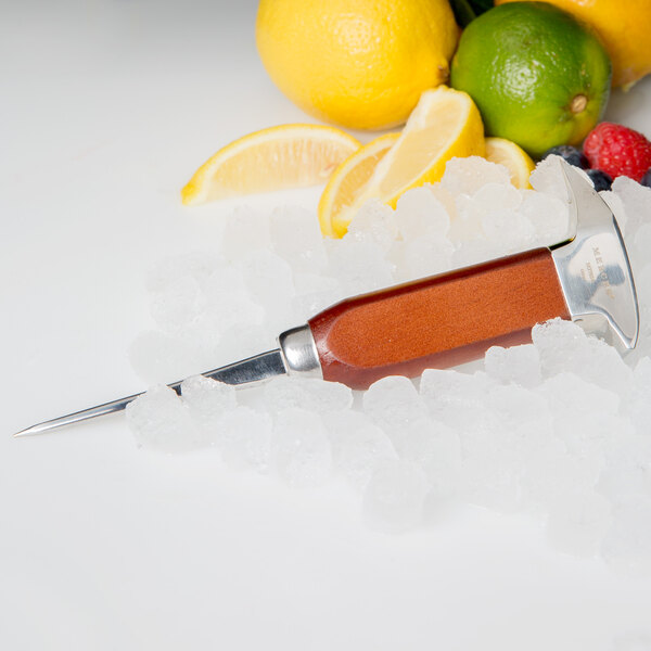 A Barfly stainless steel ice pick with a wooden handle used to put ice in a cocktail with a lemon slice.