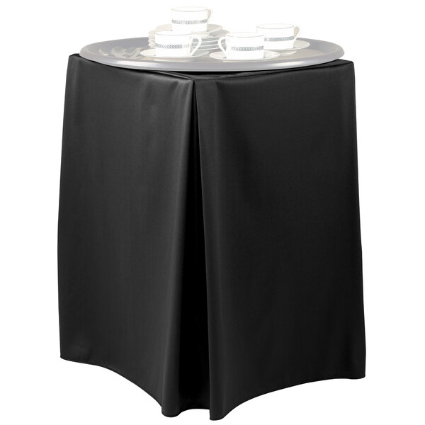 A black Snap Drape tray stand cover on a table with a silver tray of tea cups.