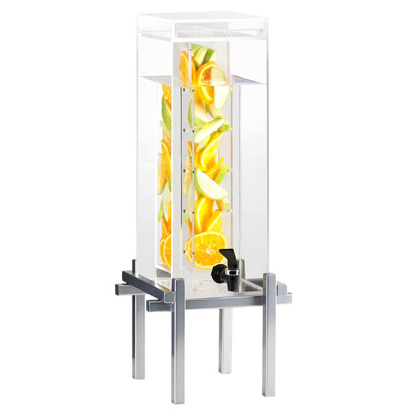A Cal-Mil silver beverage dispenser with an infusion core and fruit inside.