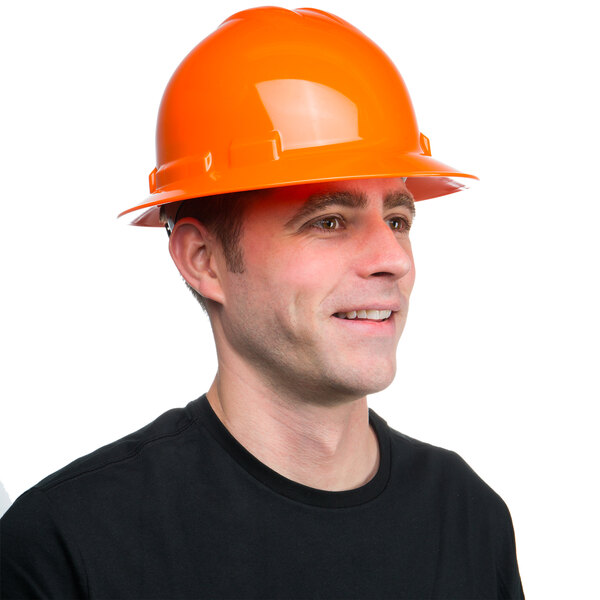 A man wearing a Cordova Duo orange hard hat smiles.