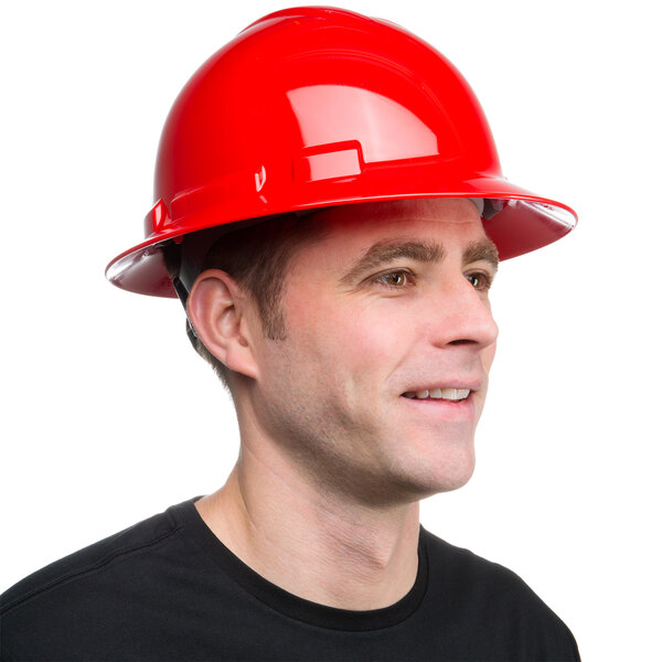 A man wearing a Cordova red full-brim hard hat with a smile.