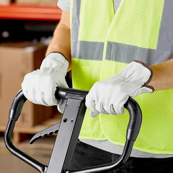 A man wearing Cordova leather driver's gloves and a safety vest.