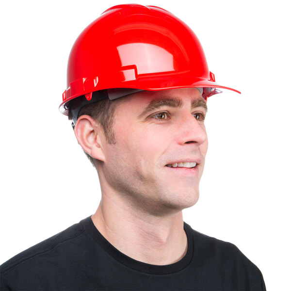 A man wearing a Cordova red hard hat and smiling.