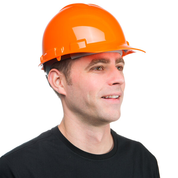 A man wearing a Cordova orange cap style hard hat and smiling.
