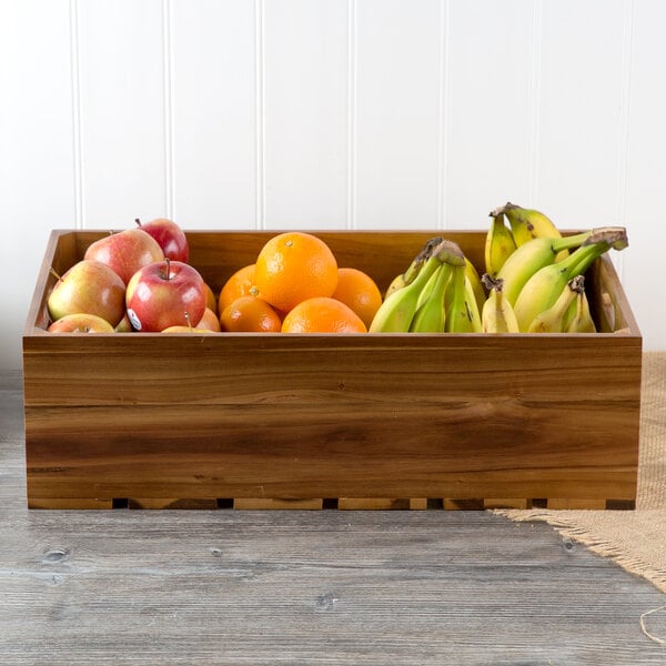A Tablecraft Gastronorm acacia wood crate filled with fruit on a table.